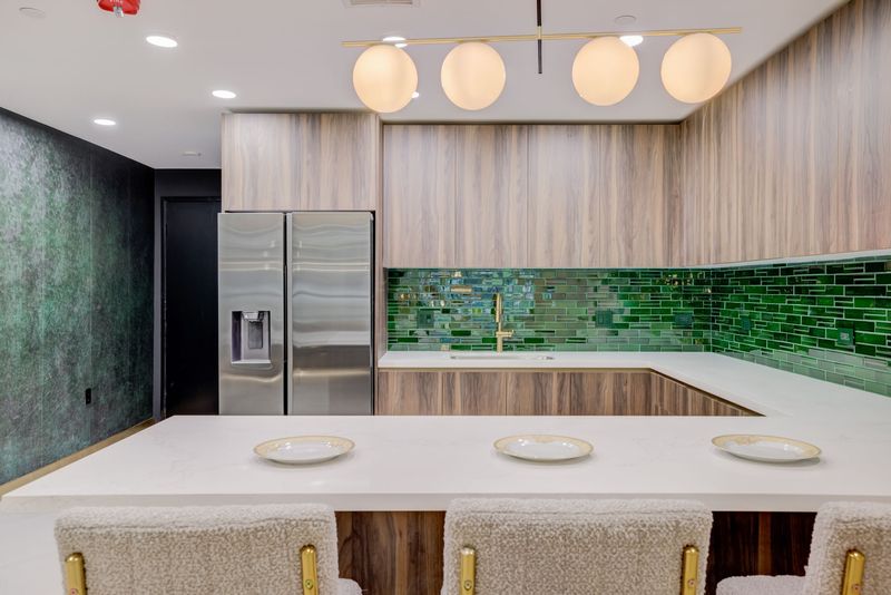 Shared entertaining kitchen with green tile backsplash at The Felix on Fairfax