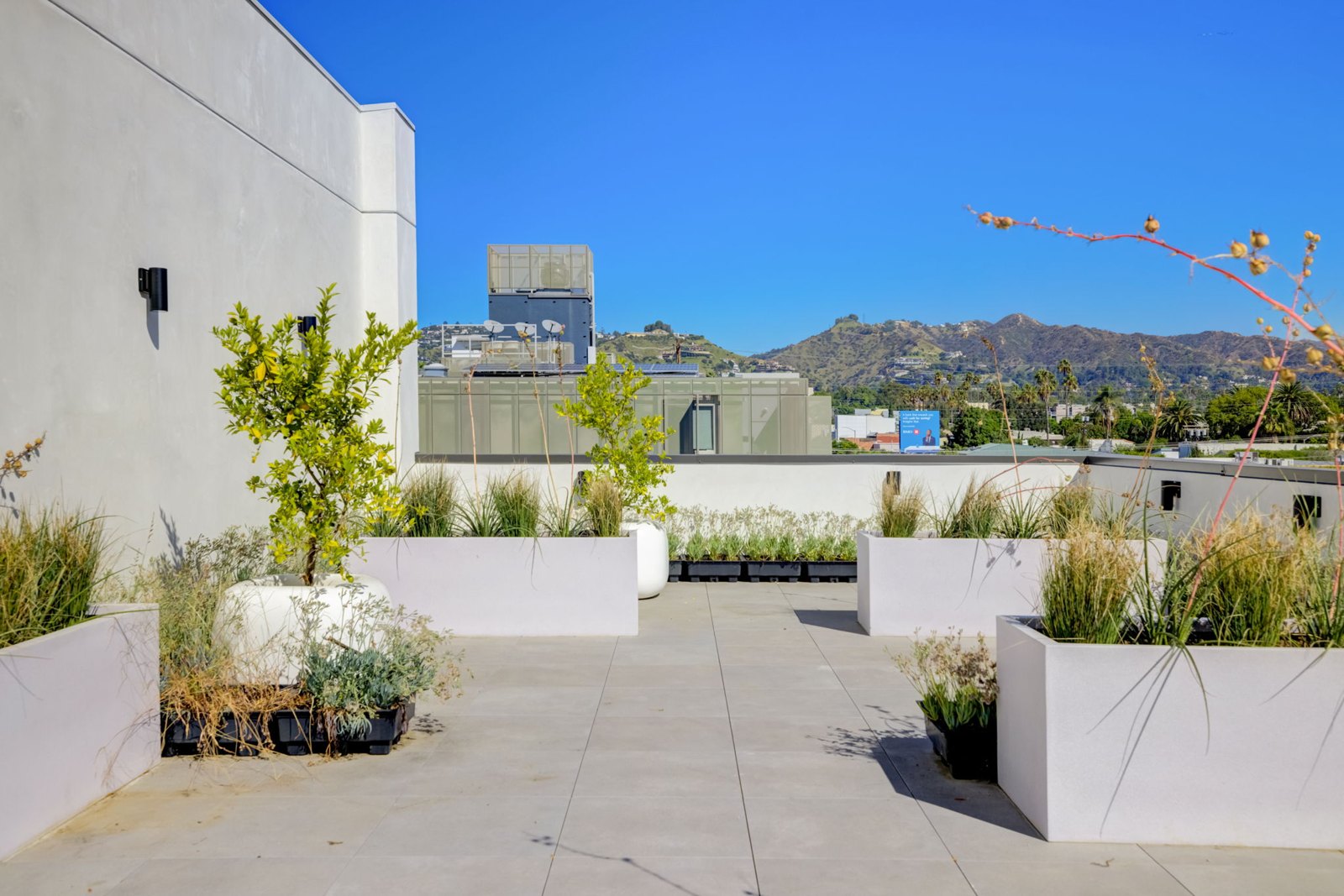 Rooftop terrace at The Felix on Fairfax with planters and Hollywood Sign views