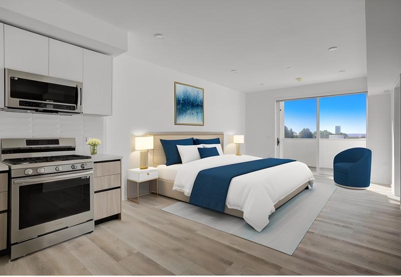 Staged bedroom at The Felix on Fairfax with balcony access
