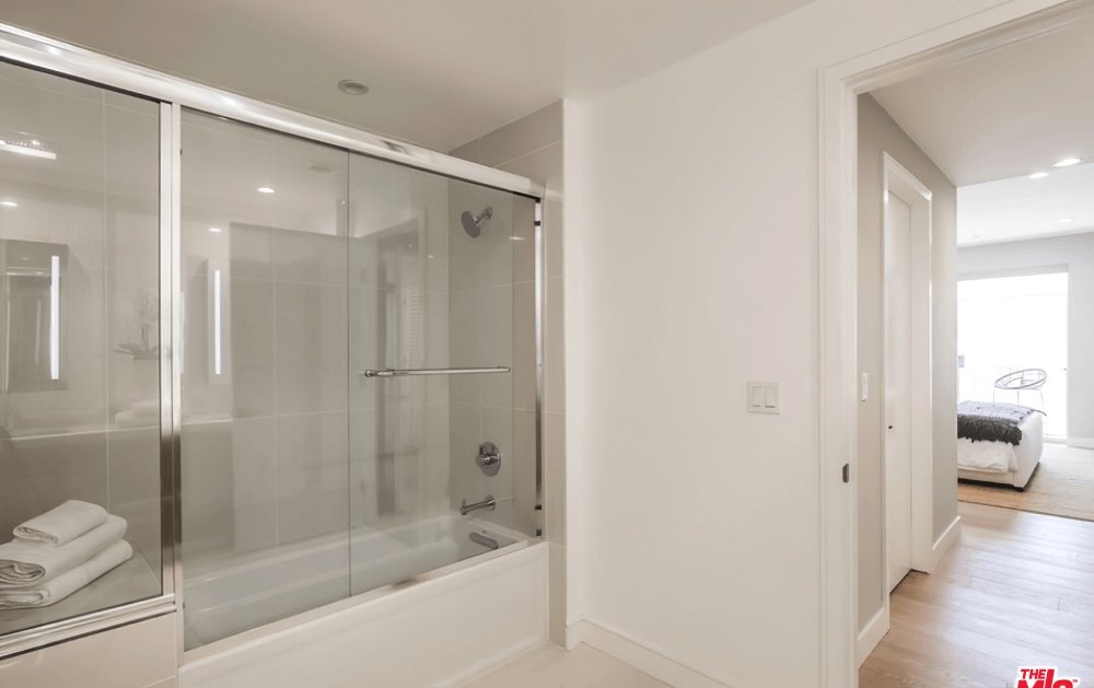Glass-enclosed shower and tub in an Olympic Towers bathroom