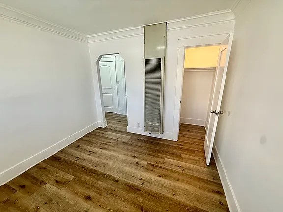 Bright bedroom with hardwood floors and closet at the Hollywood Bungalows
