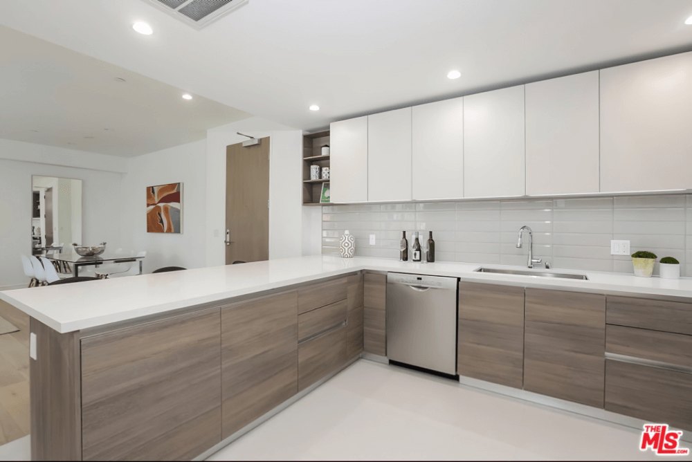 Open kitchen with two-tone cabinetry at Olympic Towers