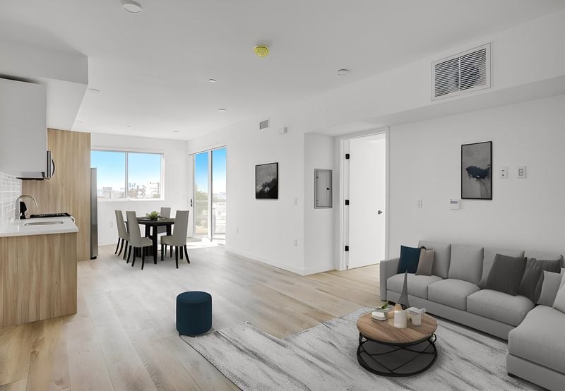 Staged open living and dining area at The Felix on Fairfax with city views