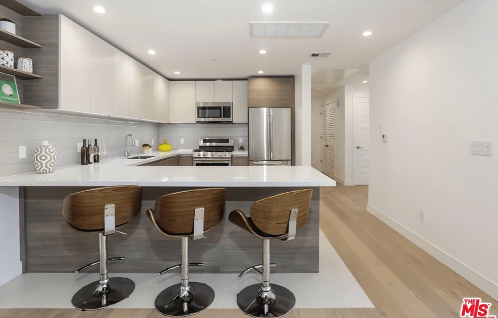 Kitchen island with bar stools in an Olympic Towers three bedroom