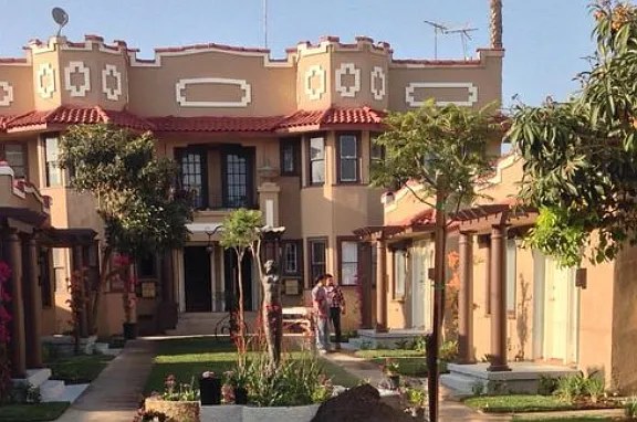 Spanish-style facade of the Hollywood Bungalows with tiled roof and arched details